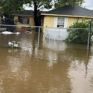 The open ditch in front of Veronica’s home is full, which does not protect her yard or her home from flooding. During this storm, she had several inches of water in her home.