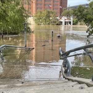 Allen’s Landing in the downtown area is the convergence of two bayous - Buffalo Bayou and White Oak Bayou. This park is wide with a steep slope to hold . Notice how the lamp posts slowly disappear into the muddy water. View from Commerce Street looking at Harris County Jail.